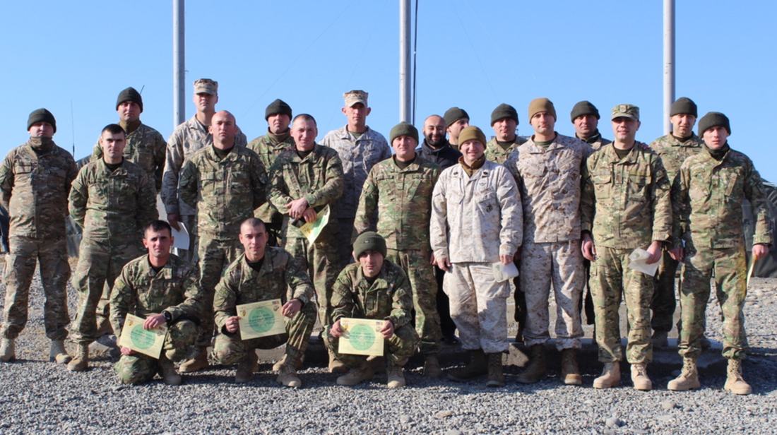 Allied troops holding certificates after a training course