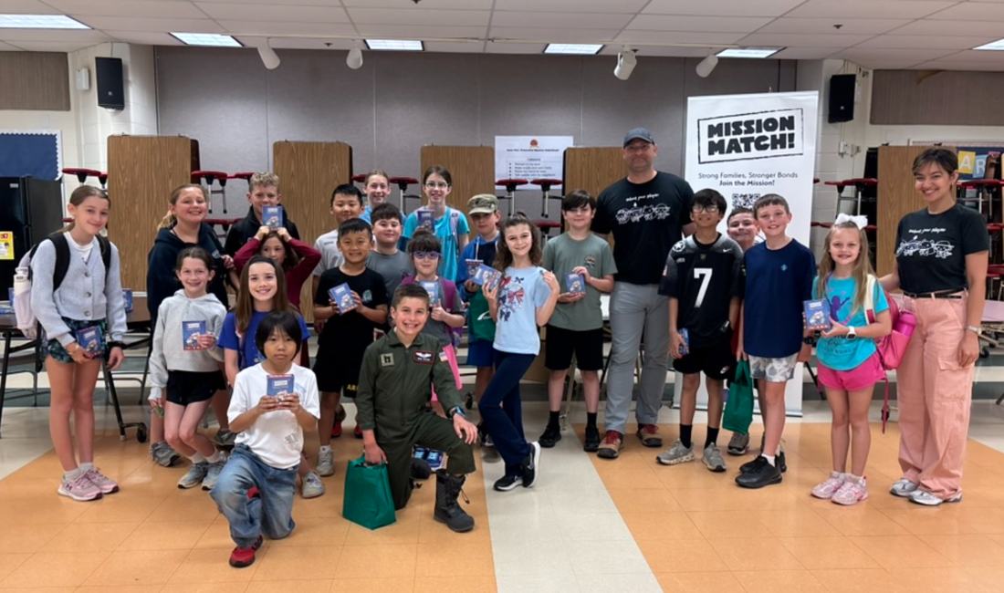 Kids holding Mission Match decks at a library event