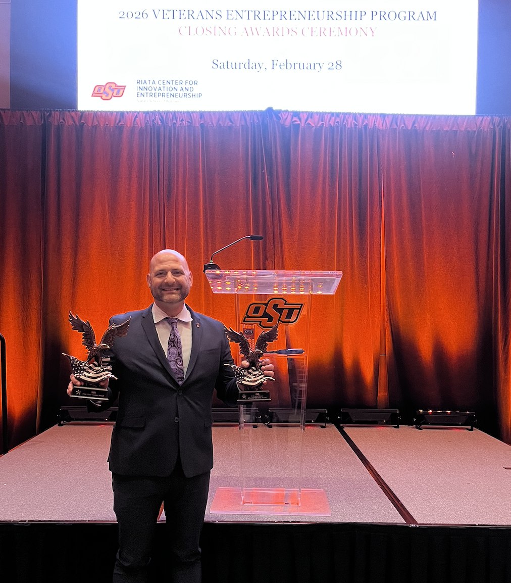Tim holding two eagle trophies at the OSU Veterans Entrepreneurship Program closing awards ceremony
