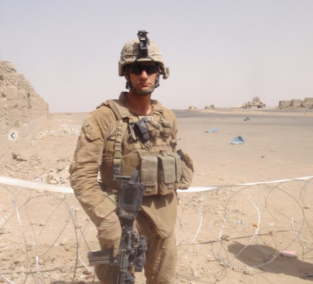 A Marine in full kit at a desert outpost