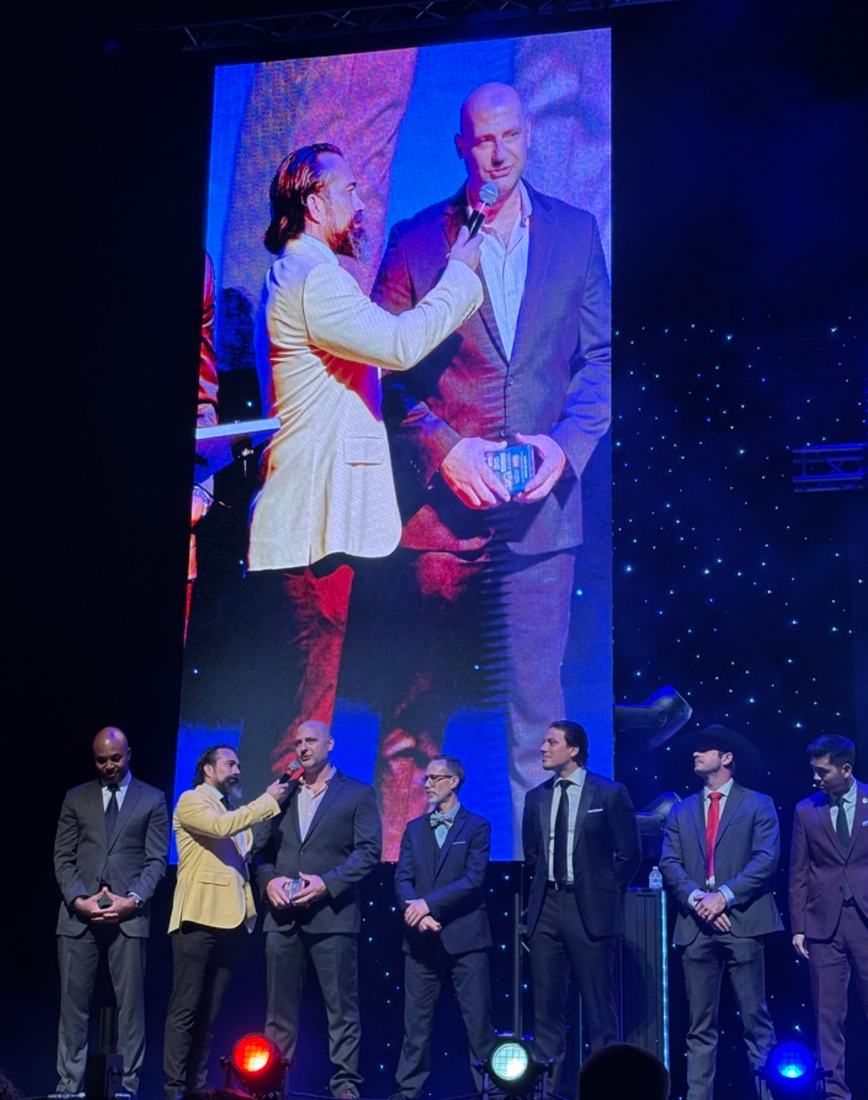Tim Gick on stage with other finalists at an awards ceremony
