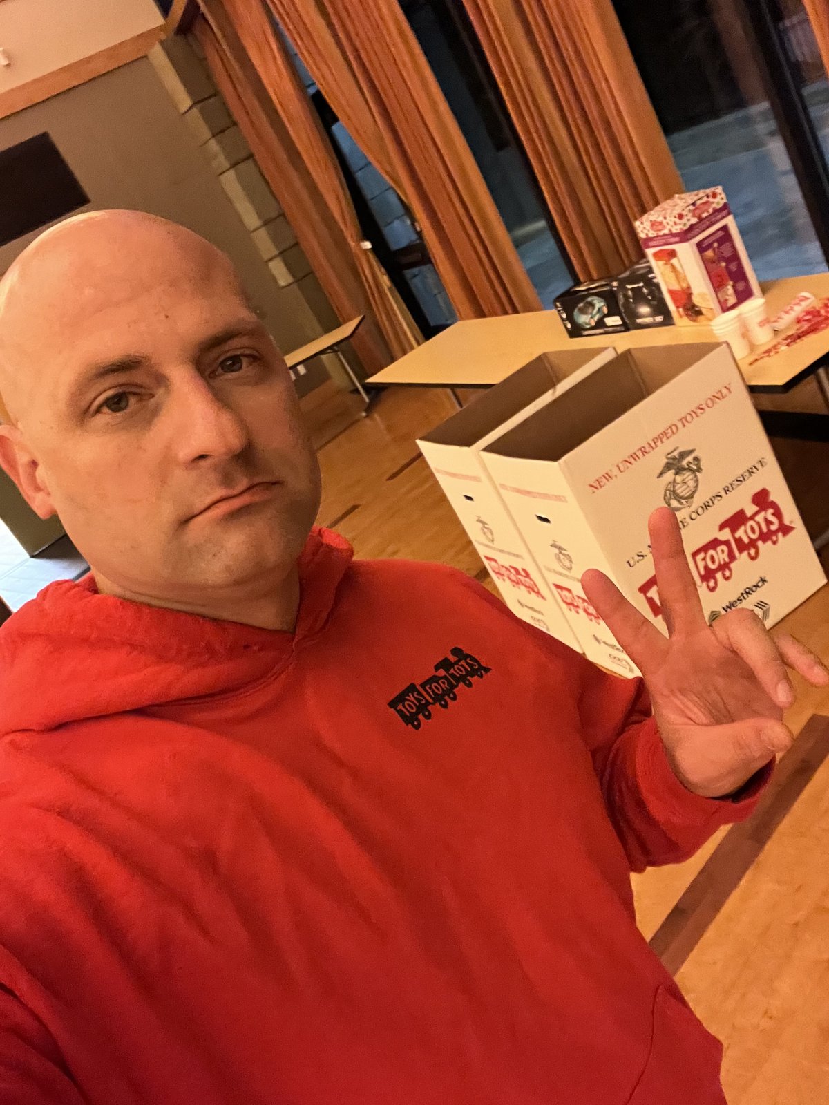 Tim holding Toys for Tots donation boxes